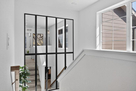 Bright stairway leading to the private upstai