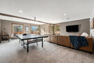 Downstairs living area with ping pong table