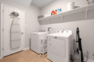 Full laundry room with washer and dryer insid