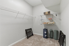 Walk-in closet in primary bedroom with yoga m