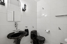 The main level hall bath has a stunning black