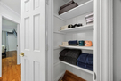 Closet with bath towels, wash cloths and bed 