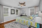 Main floor bedroom with nightstands, dresser 
