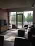 Floor to ceiling windows and balcony off of l