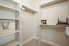 Luxurious walk-in closet in master suite