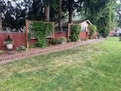 Spacious partially fenced backyard.