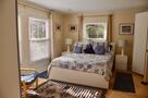 Bedroom with Queen bed windows look onto the 
