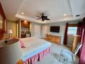 Loft bedroom features wet bar and mini fridge
