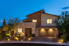 Front of home, well lit and mature landscape