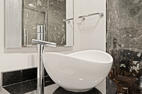 Vessel sink and richly veined marble bathroom