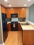 Modern Kitchen with hardwood floors, glass ti