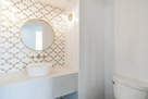 Powder Room with Marble accent wall
