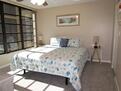 Back master suite with king bed and bathroom