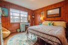 Bedroom #2 with original knotty pine is warm 