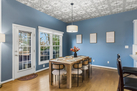 Dining table and door leading out to backyard