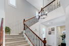 stairs featuring recessed lighting,chandelier