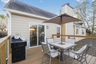 Deck with outdoor seating and gas grill.