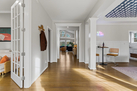 Hallway opens up to entertainment room and of