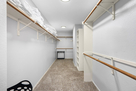Walk-in master closet with ample storage and 