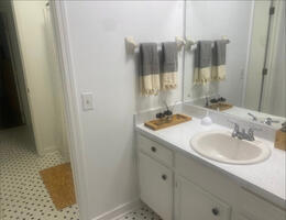 Two vanity areas with shared shower/tub