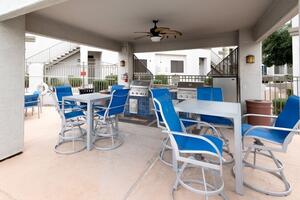 Covered Patio with mini fridge and grill at the pool