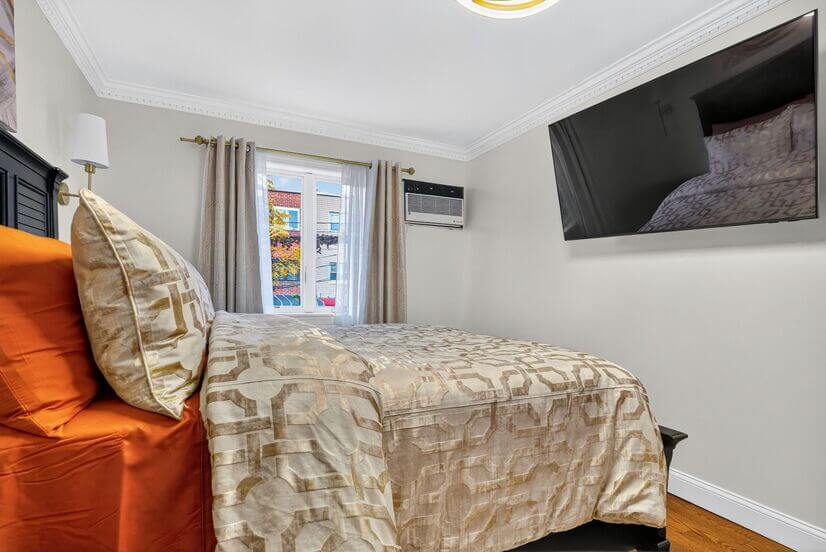 Bedroom that has full size window, air conditioning