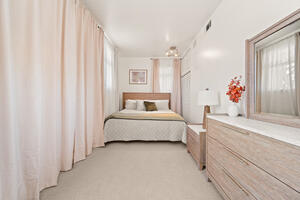 King bedroom with dresser and closet