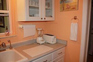 Kitchen with blender and toaster.