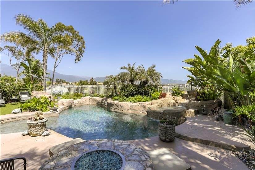 Backyard pool and jacuzzi with view of city a