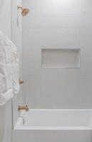 Spa-style bath with rainfall shower and tile