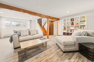 Family Room Wide View with Seating, Stairs, and Built-In She