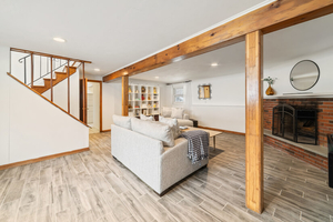 Family Room Perspective with Beams, Fireplace, and Stairs