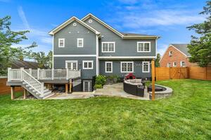 Large backyard with flagstone patio and deck