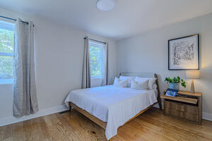 Spacious, bright queen bedroom with blackout