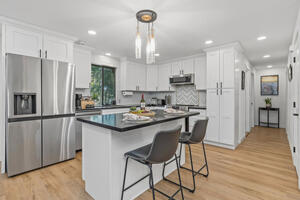 Open layout, island seating, and deck access.