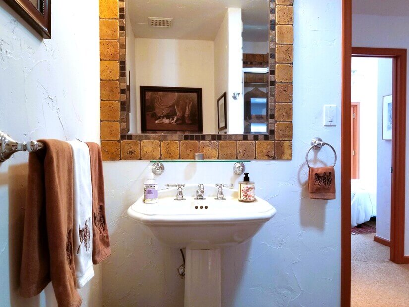 Hallway bath is conveniently across from small bedroom