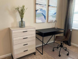 The spacious bedroom doubles as a home office