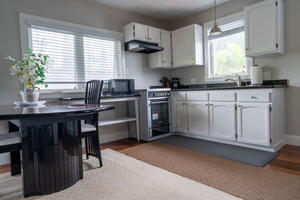 Open kitchen/dining w/fullsize refrigerator.