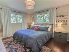 Light filled primary bedroom with king bed, s