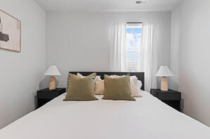 Reeded bed with vibrant green accents and soft art