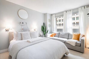Cozy bedroom with comfy mattress and a couch