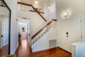 A Welcoming Foyer and Gorgeous Hardwood Floors Greet You