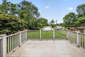 Large deck for entertaining overlooking the 1/4 acre lot.