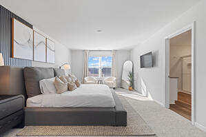 Wingback bed with luxe decor and blackout curtains.