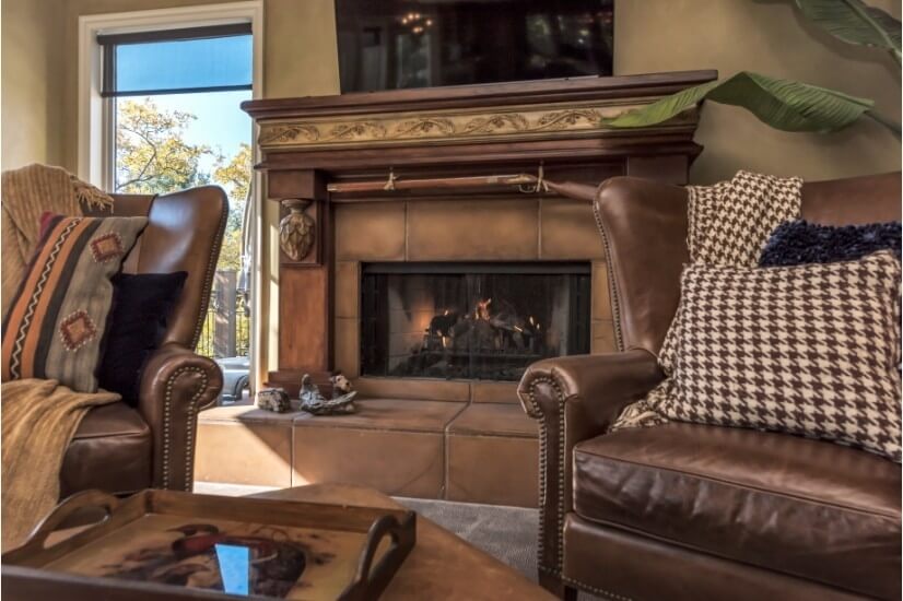 Hand carved mantel w/ gas fire place & large, flat screen TV