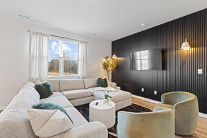 Plush sectional with boucle chairs and wood accents