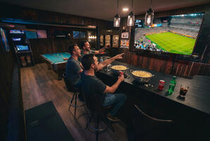 Large screen TV and bar seating.