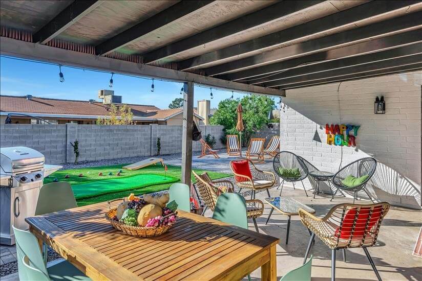 comfortable back patio with smart TV and BBQ