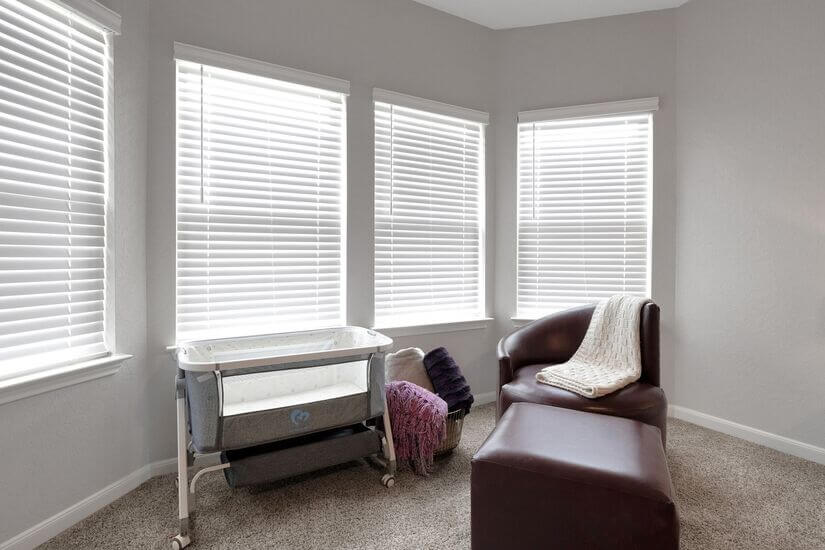 Crib and nursing chair for baby-friendly comfort.