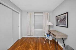 Office main floor has desk and ample space for a crib